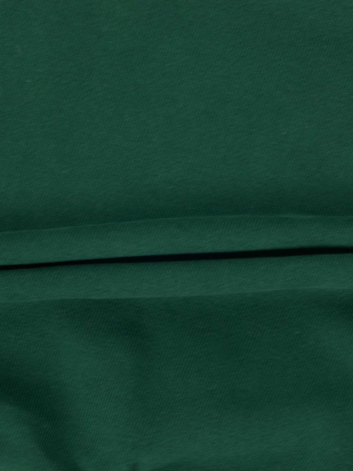 Dark green hockey sweatshirt fabric close-up with folded hem.