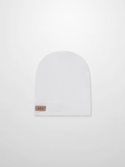 Legacy Stitch Hat by Adee, white unisex rib-knit beanie with tan leather patch.