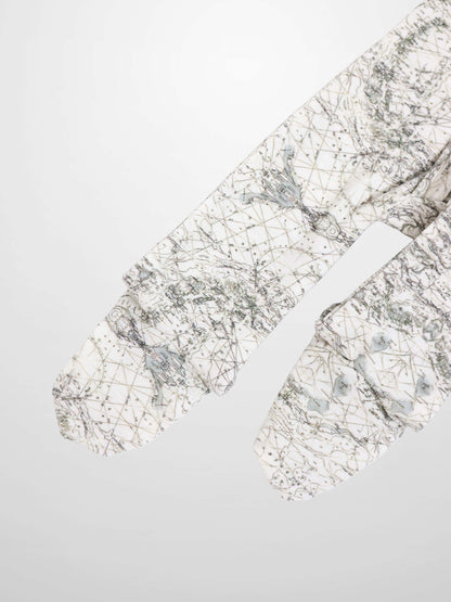 Map Stretchy baby jumpsuit footie fabric in off-white with sage green map lines and compass markers.