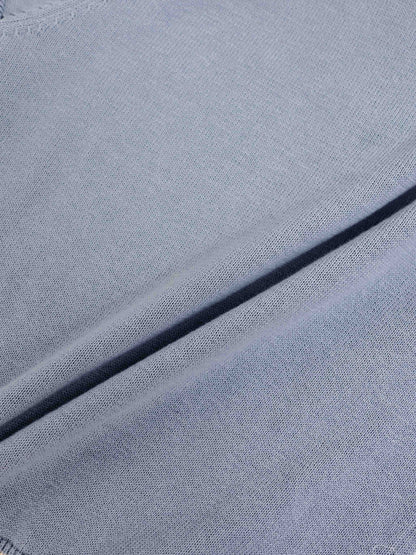 Light blue knit sweater fabric close-up with soft, fine texture.