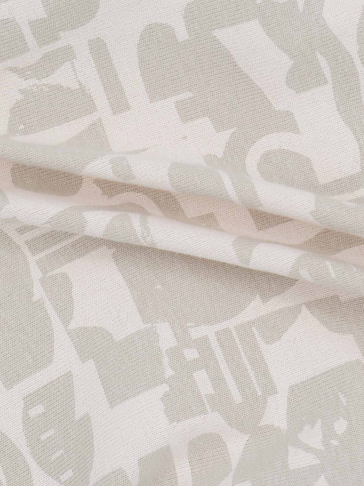 Soft neutral abstract print fabric with beige and ivory shapes.