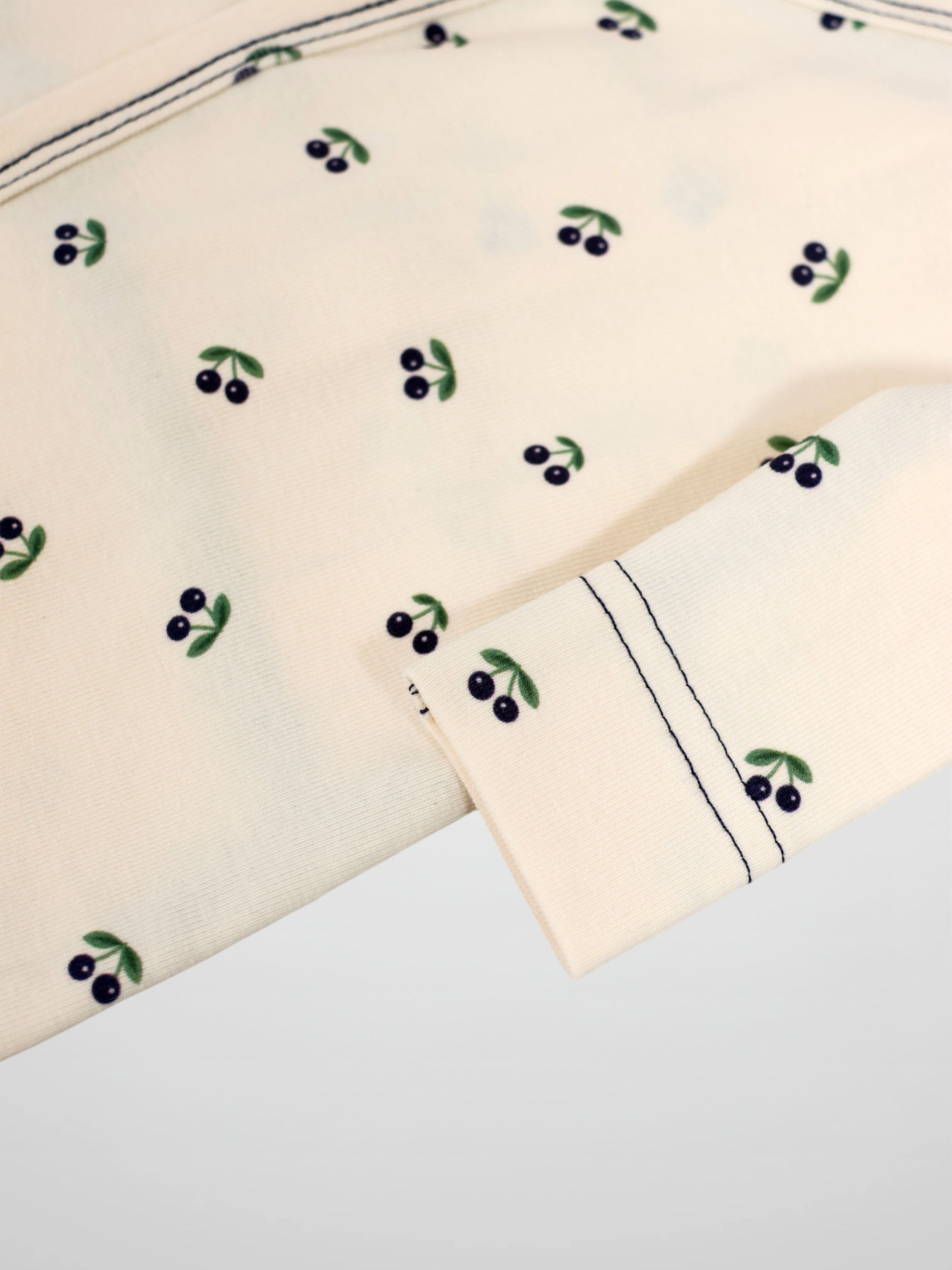 Blue Cherry Stretchy top for boys in cream fabric with blue cherries and green leaves by Adee