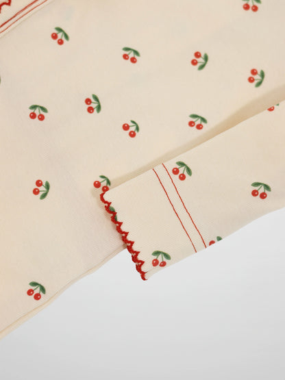 Red Cherry Stretchy girls stretchies with bright red cherries on green fabric