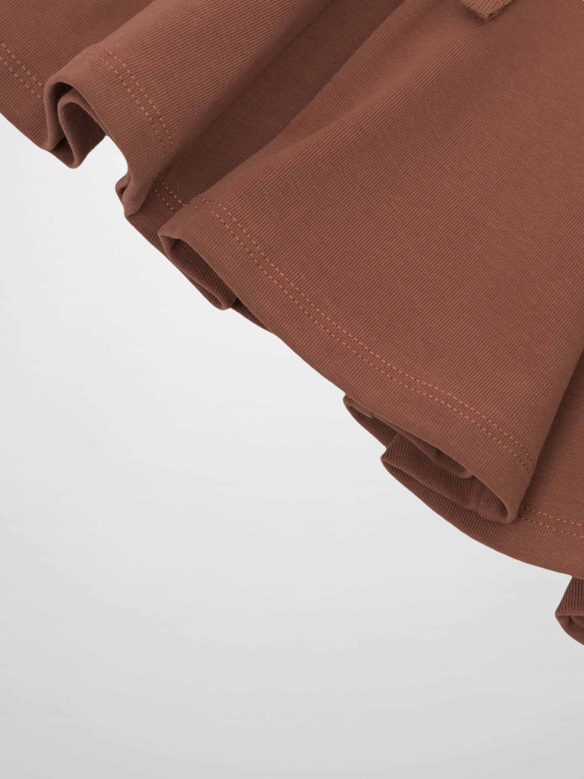 Dark mauve six-panel skirt fabric, close-up of rolled hem and stitching