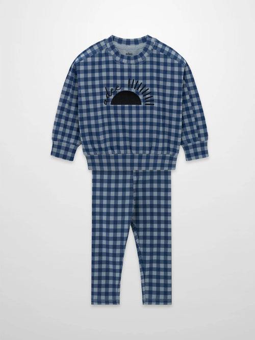 Blue gingham pajama set with long-sleeve top and matching pants, sun graphic on the chest.