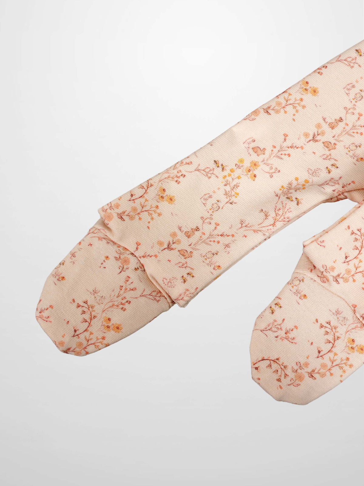 Sweet Meadow Stretchy girls jumpsuit in light pink floral print with long sleeves.