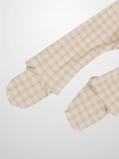 Beige oatmeal grid plaid fabric on baby romper sleeves with light blue and brown lines.