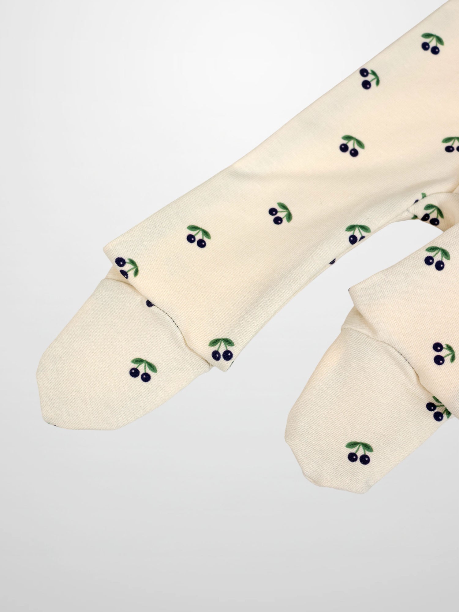 Blue Cherry Stretchy boys stretchies by Adee; cream fabric with blue cherries and green leaves.