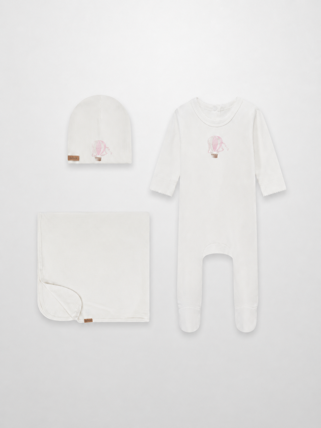 Pink Balloon three-piece layette set by Adee: white hat, blanket, and footed sleepsuit with pink balloon motif.