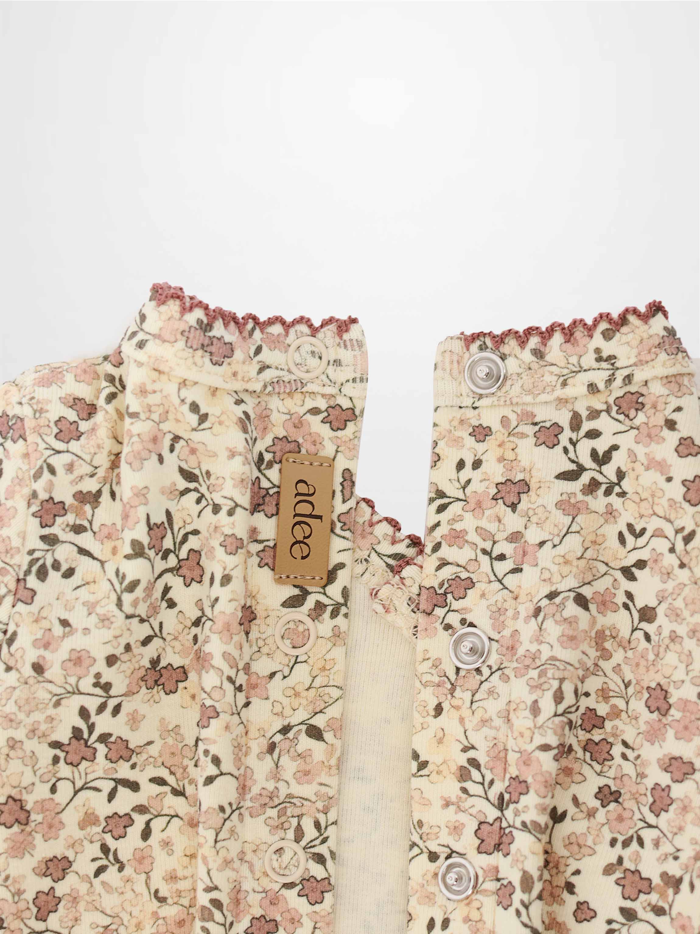 Purple Flower Stretchy girls Stretchies cardigan by Adee with cream floral print and button front.