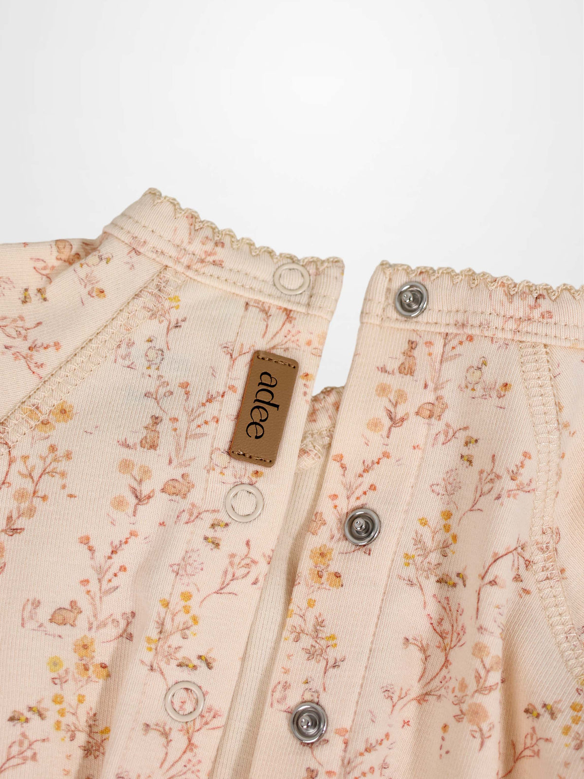 Sweet Meadow Stretchy girls jumpsuit in light pink floral print with snap buttons, Adee