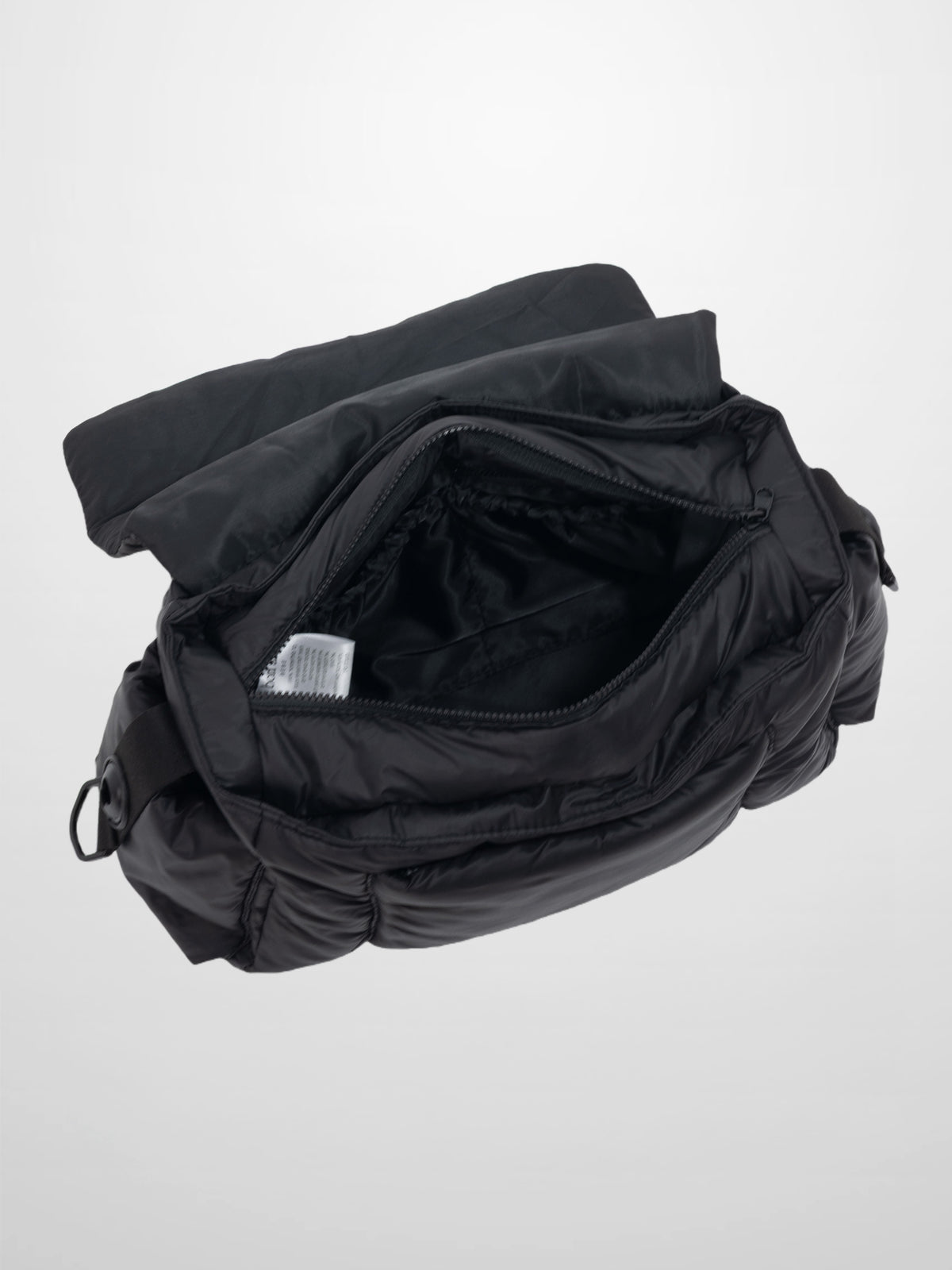 Diaper bag with black padded fabric and foldover design, a sleek, practical carry solution for modern parents.