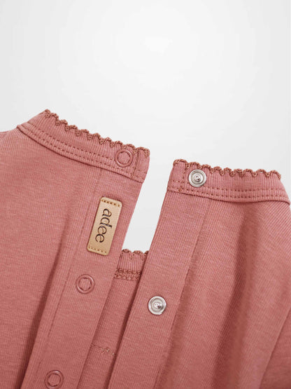 Cherry Frame Stretchy girls stretchies jumpsuit in muted pink by Adee with metal snap buttons