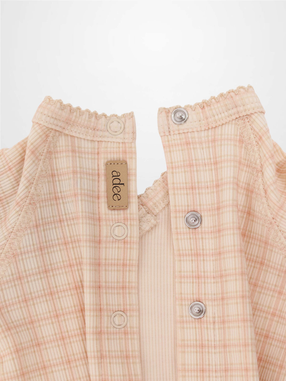 Oatmeal Grid Stretchy pink girls stretchies by Adee; plaid fabric, elastic neckline, metal snaps.