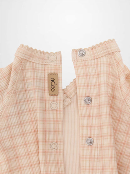 Oatmeal Grid Stretchy pink girls stretchies by Adee; plaid fabric, elastic neckline, metal snaps.