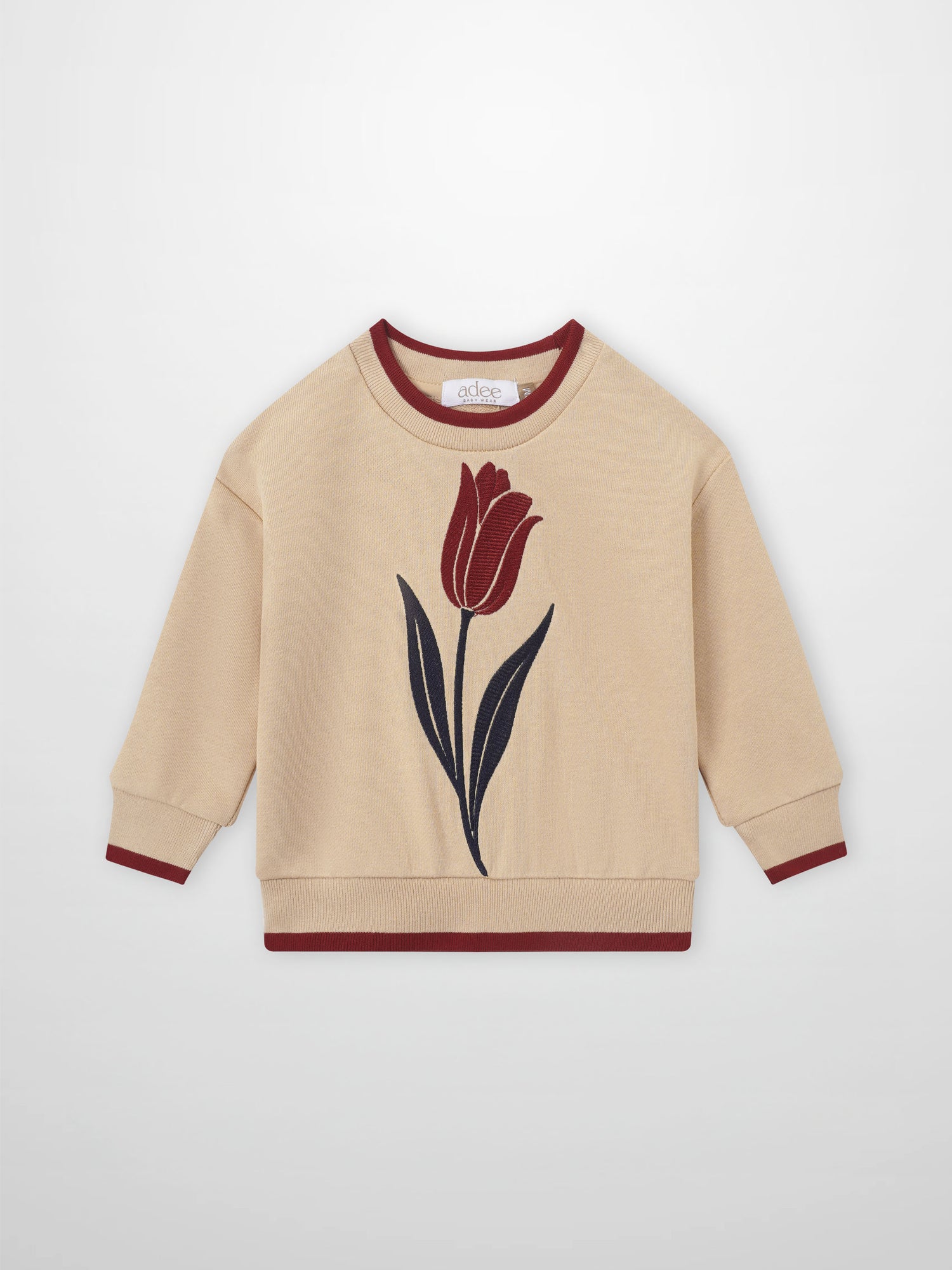 Embroidered tulip sweatshirt, beige with red tulip design, maroon ribbing at cuffs and hem, Adee brand.