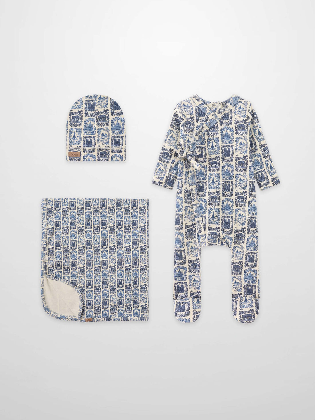 Blue Landmark layette set for boys by Adee; hat, blanket, and footed sleeper in blue toile print.