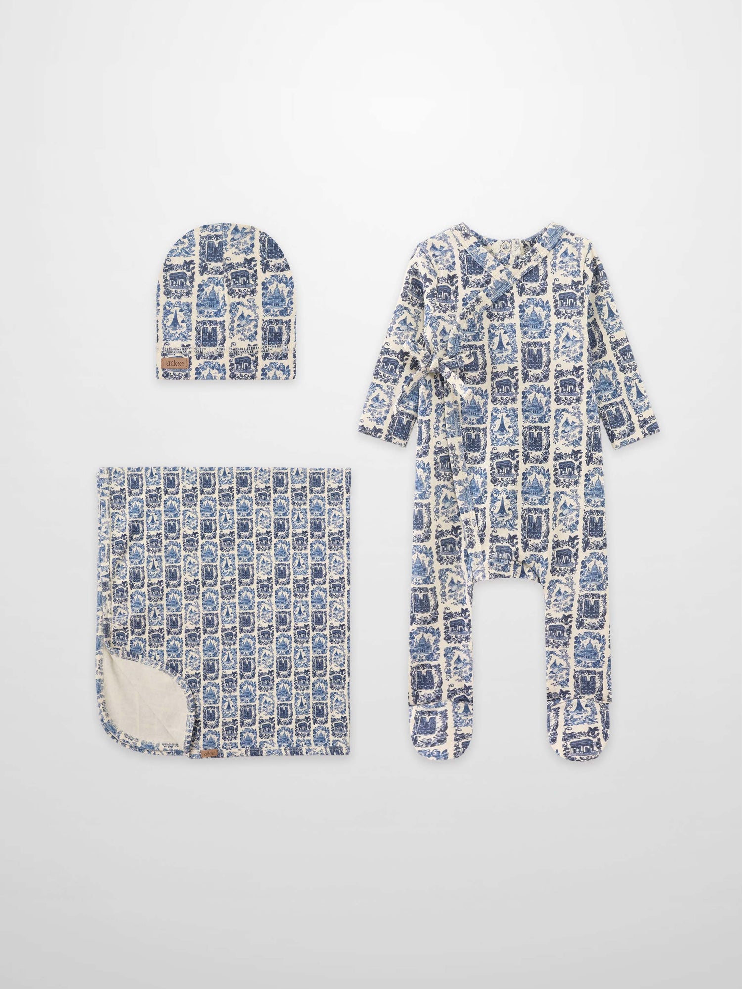Blue Landmark layette set for boys by Adee; hat, blanket, and footed sleeper in blue toile print.