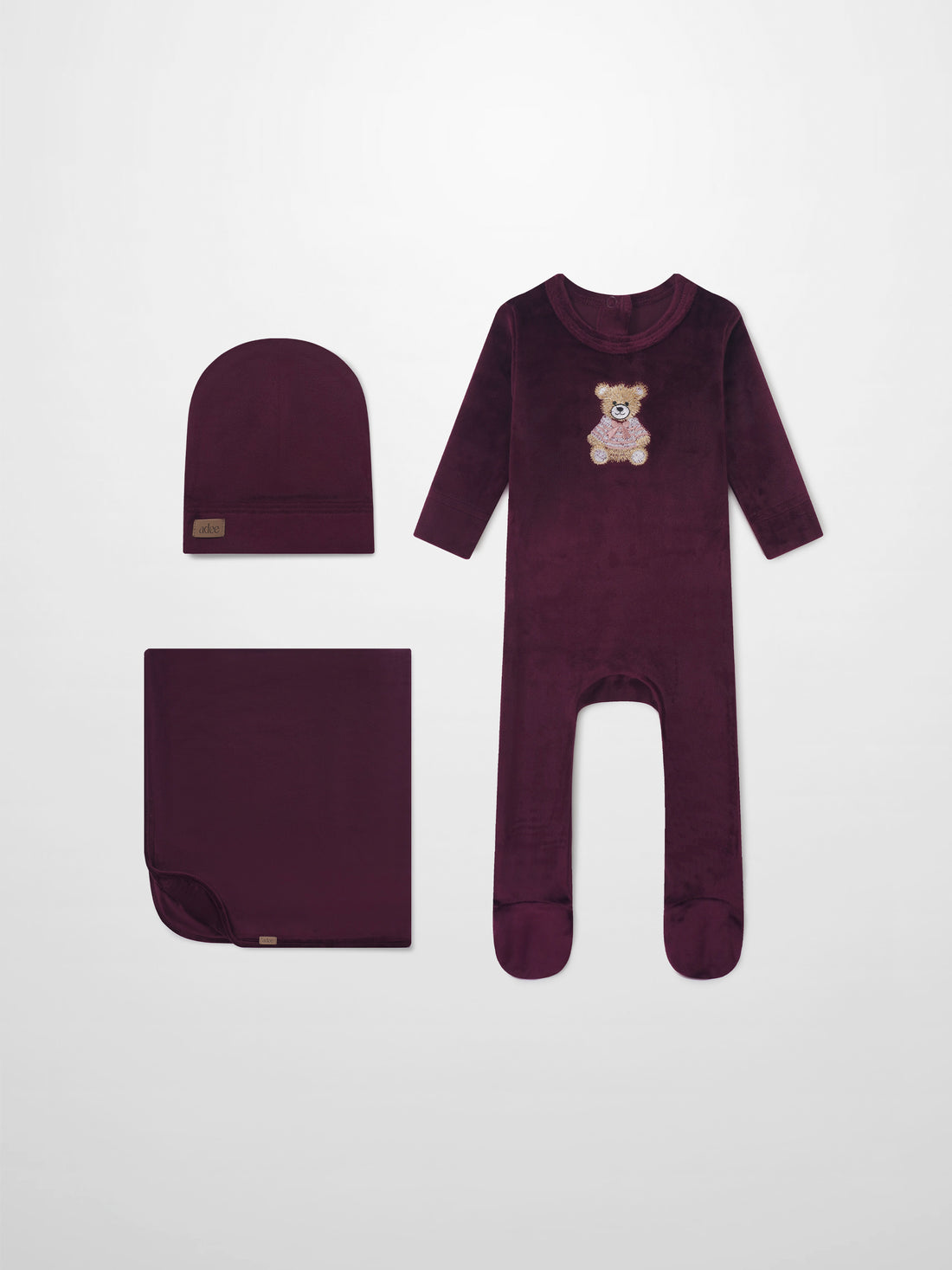 Embroidered Bear Burgundy layette set by Adee; burgundy 3-piece with bear embroidery—long-sleeve onesie, hat, and blanket.