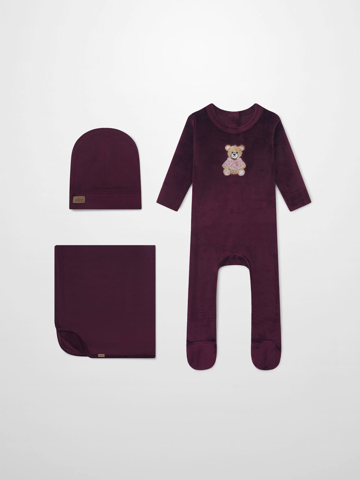 Embroidered Bear Burgundy layette set by Adee; burgundy 3-piece with bear embroidery—long-sleeve onesie, hat, and blanket.