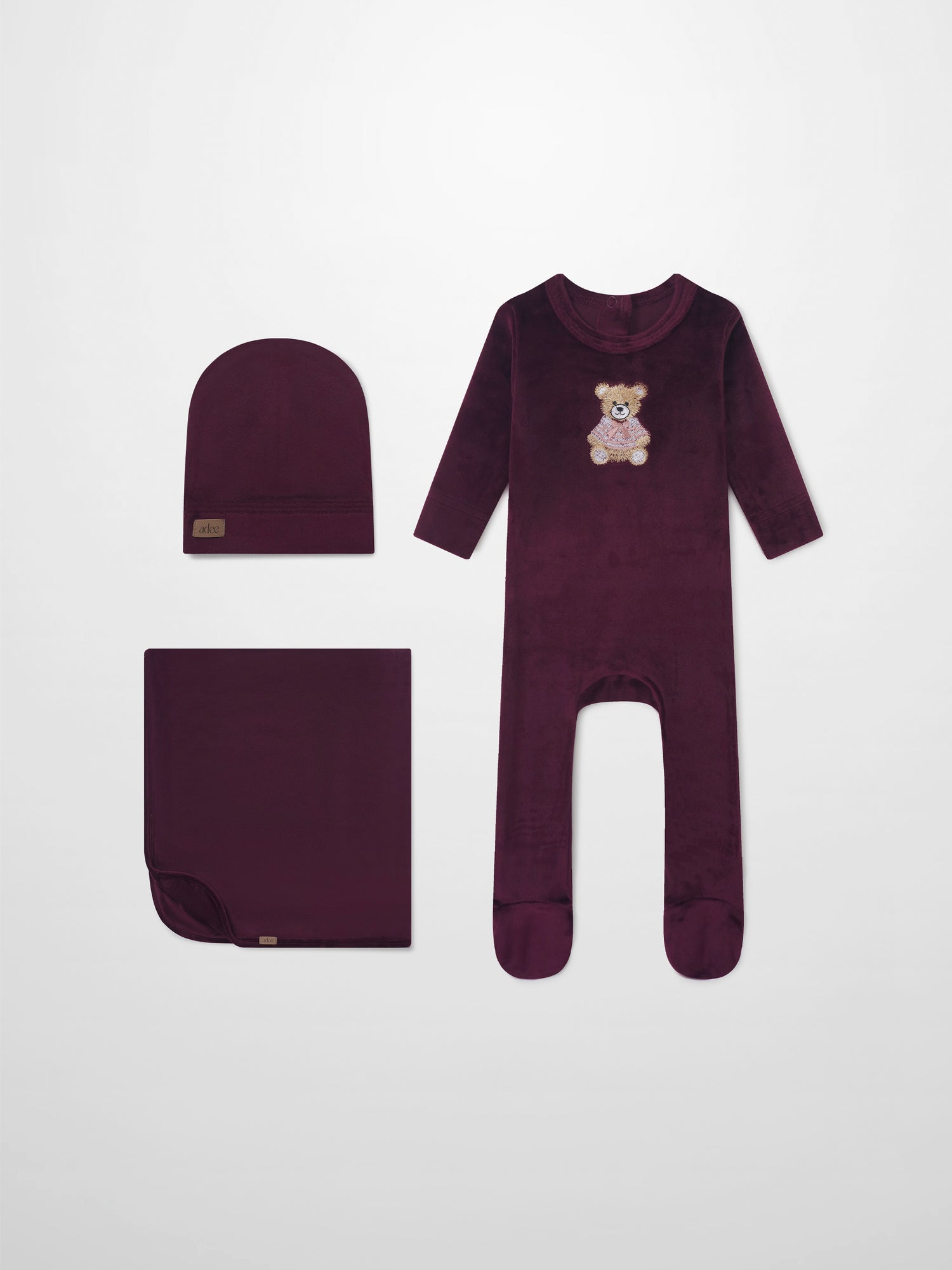 Embroidered Bear Burgundy layette set by Adee; burgundy 3-piece with bear embroidery—long-sleeve onesie, hat, and blanket.