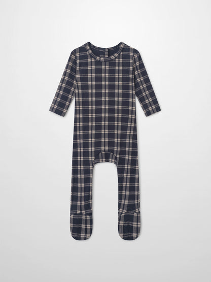 Navy plaid layette set for boys; long-sleeve footed romper in navy with beige checks.