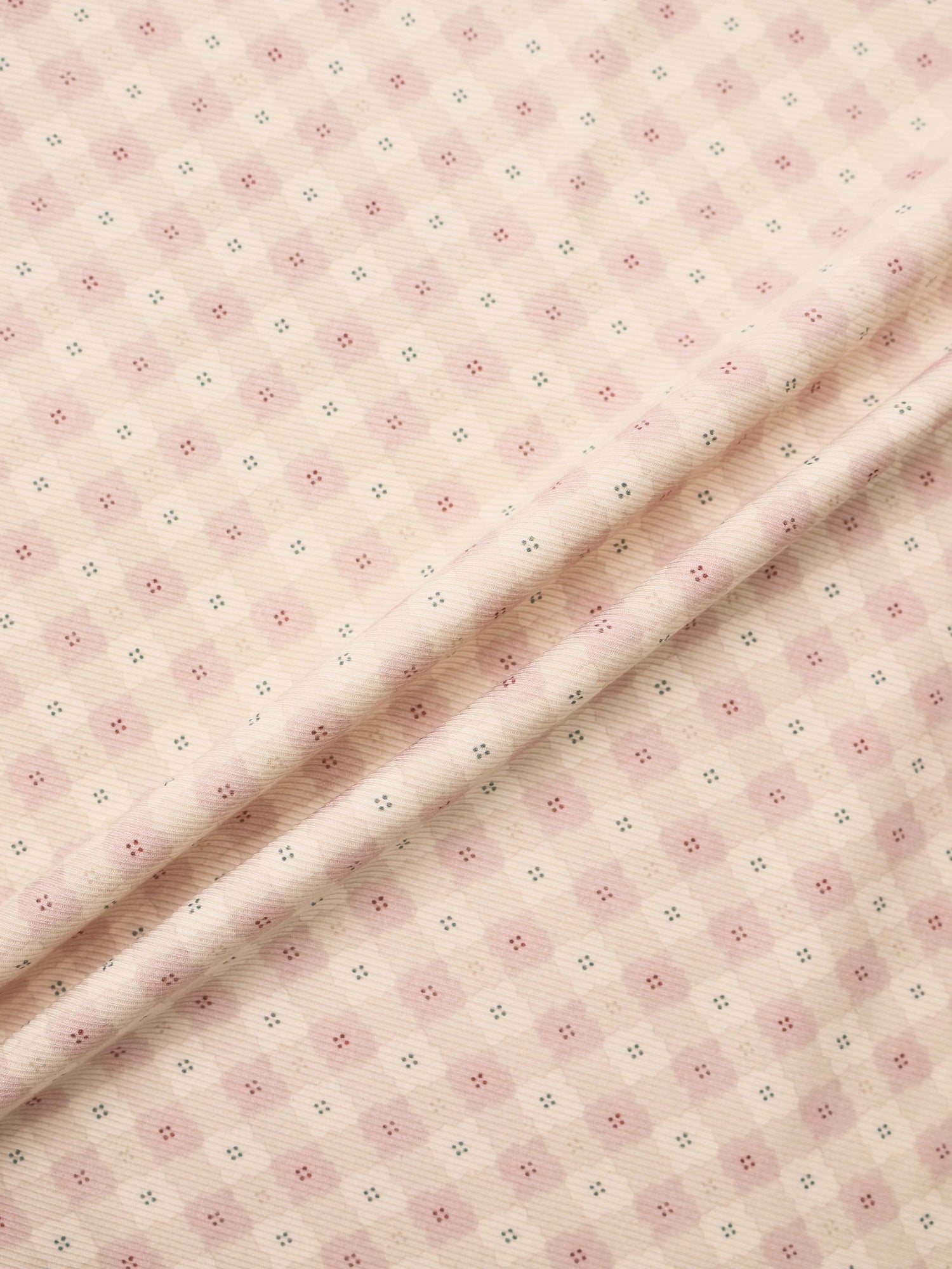 Little Button Stretchy Pink by Adee, pink knit fabric for girls with tiny pink and teal dot motifs.