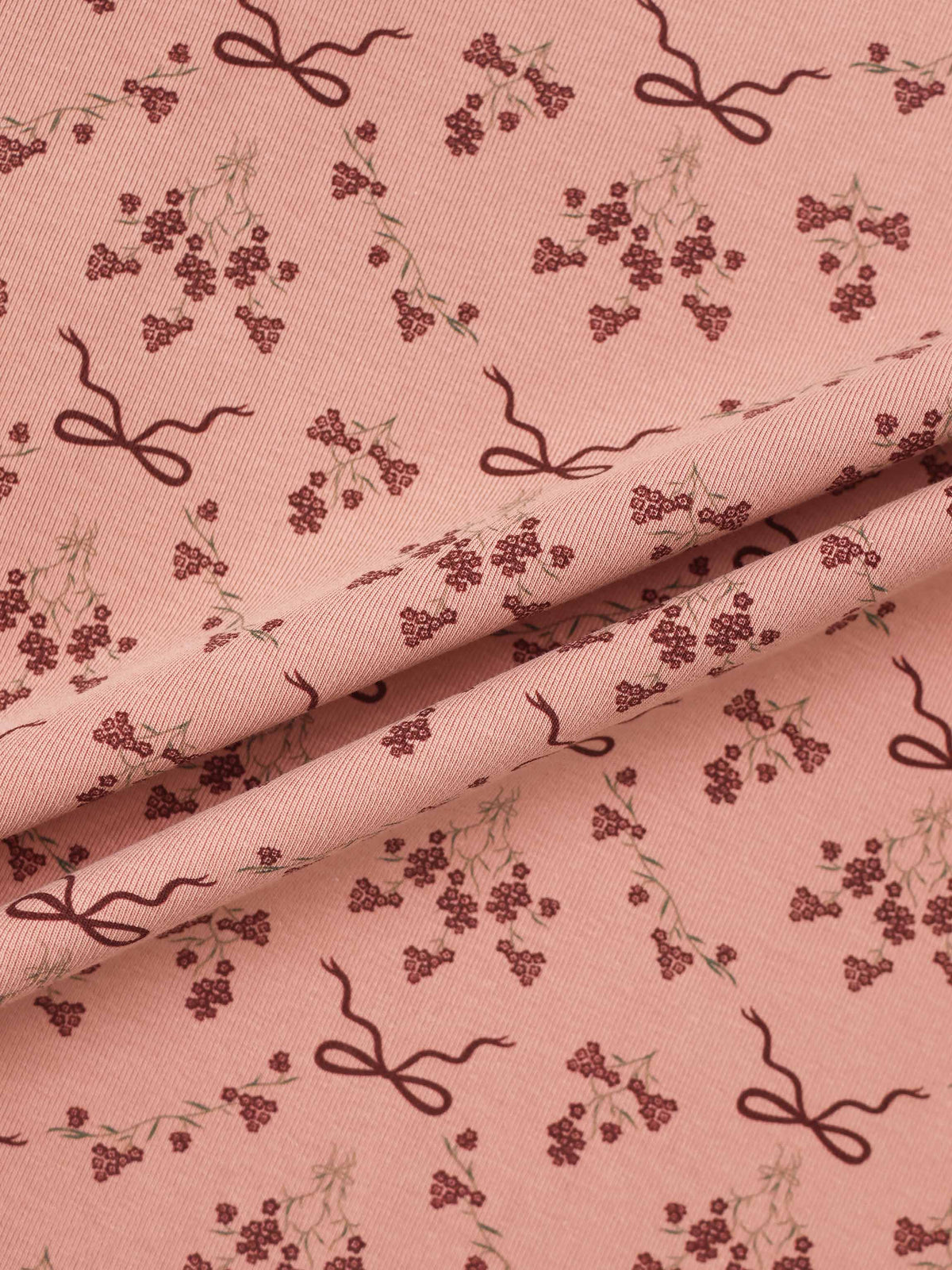 Bow Bouquet Stretchy girls stretchies fabric in pink with burgundy bows and tiny floral clusters.