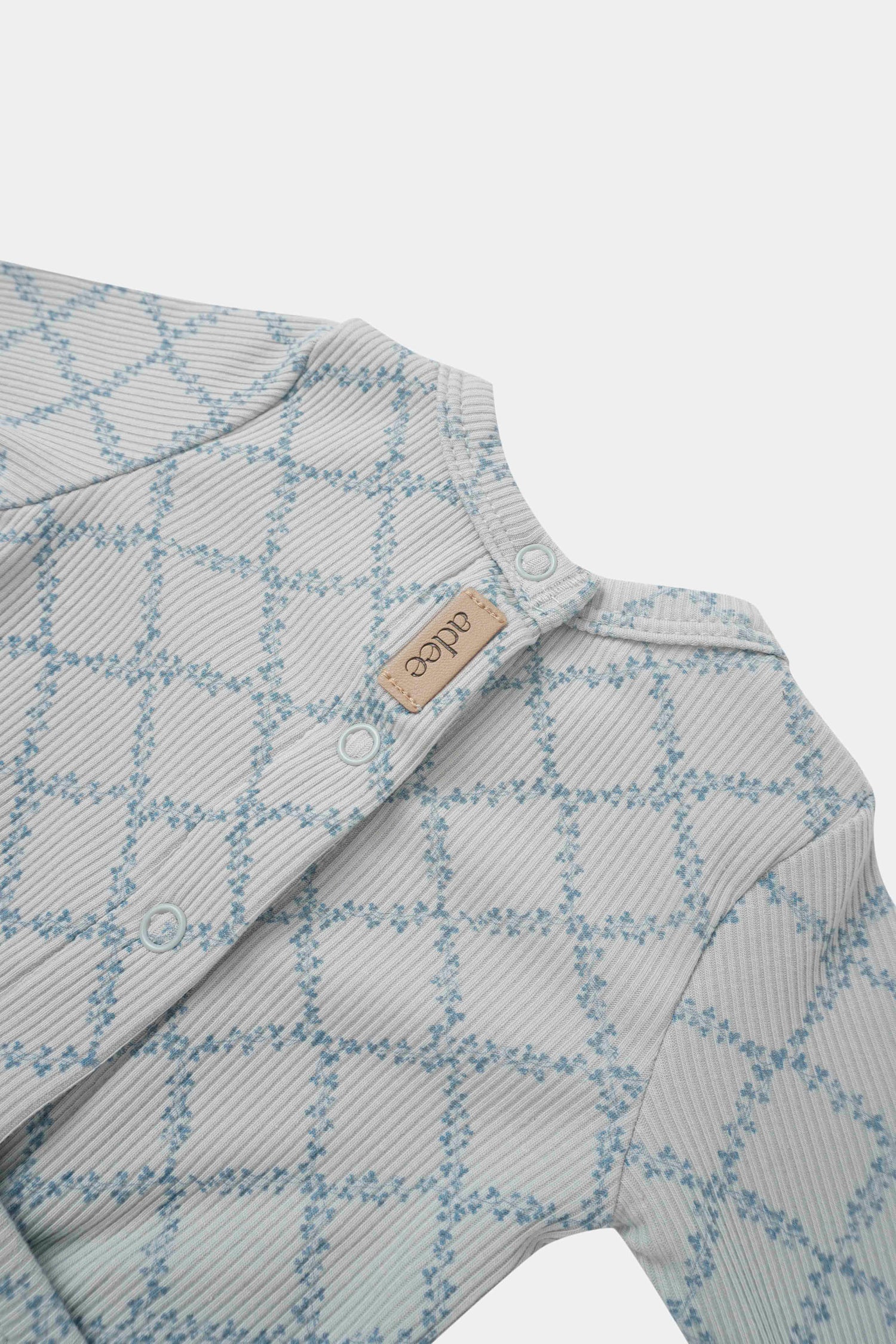 Blue Leaf Stretchy boys top by Adee; light gray striped fabric with blue leaf pattern and snap placket.