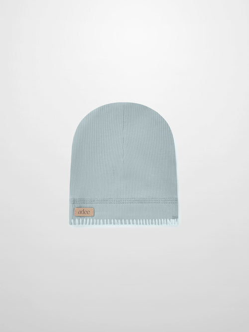 Legacy Stitch Hat by Adee in light blue knit for boys; ribbed cuff with leather patch.