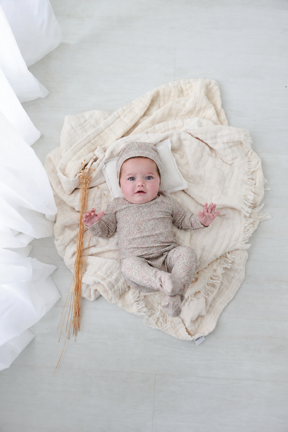 Pastel Petal Stretchy girls stretchies by Adee; beige floral knit baby romper with hat on a soft blanket