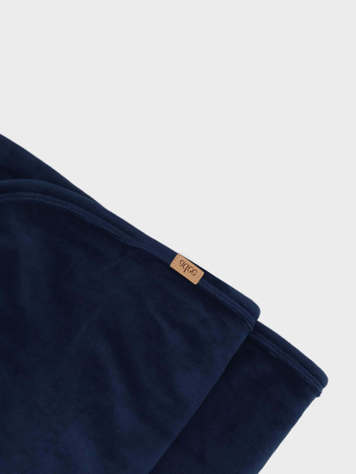 Adee Velour Blanket for boys in navy with a tan brand tag