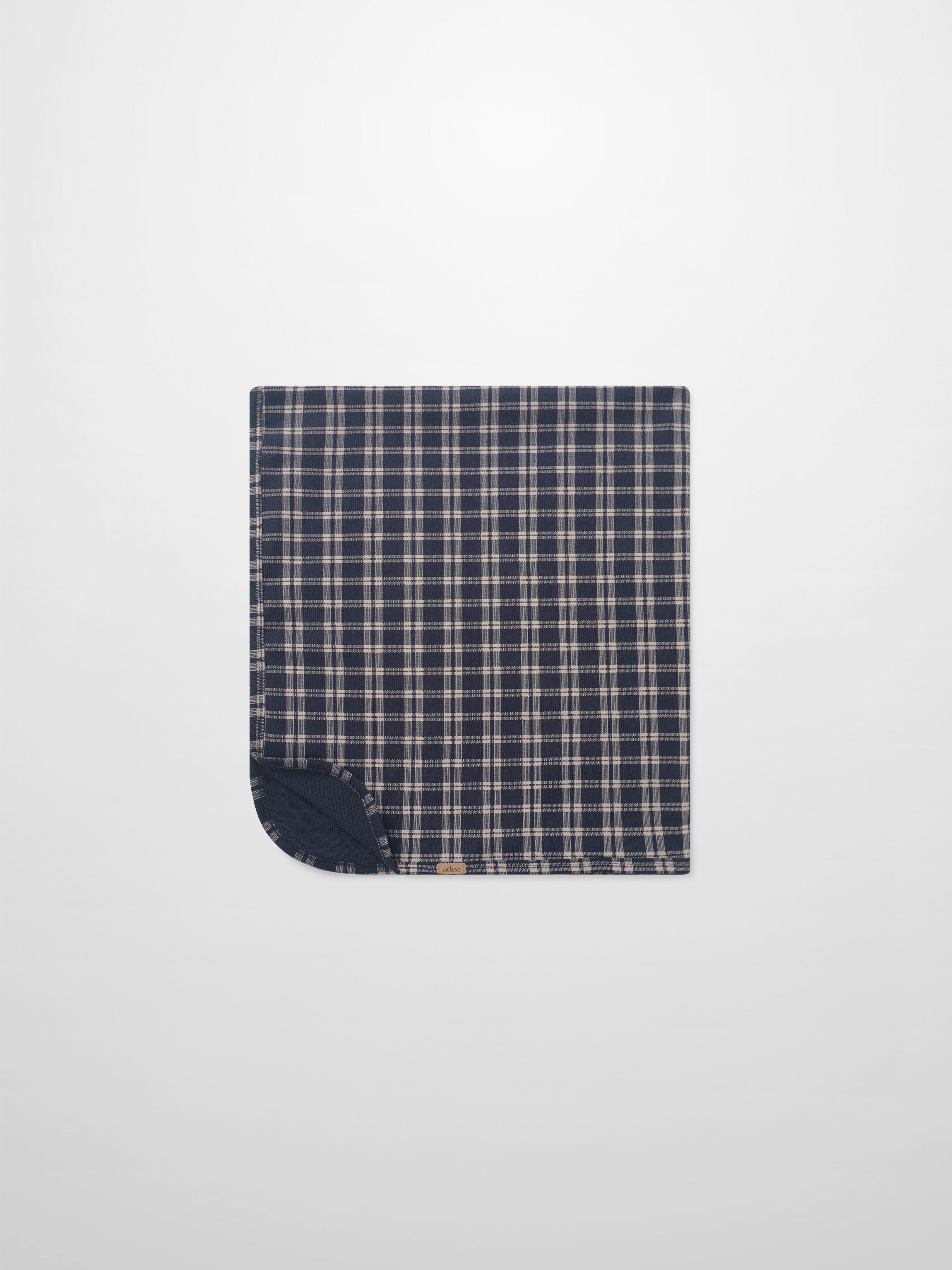 Navy plaid blanket swaddle for boys by Adee; navy plaid outer with solid navy backing
