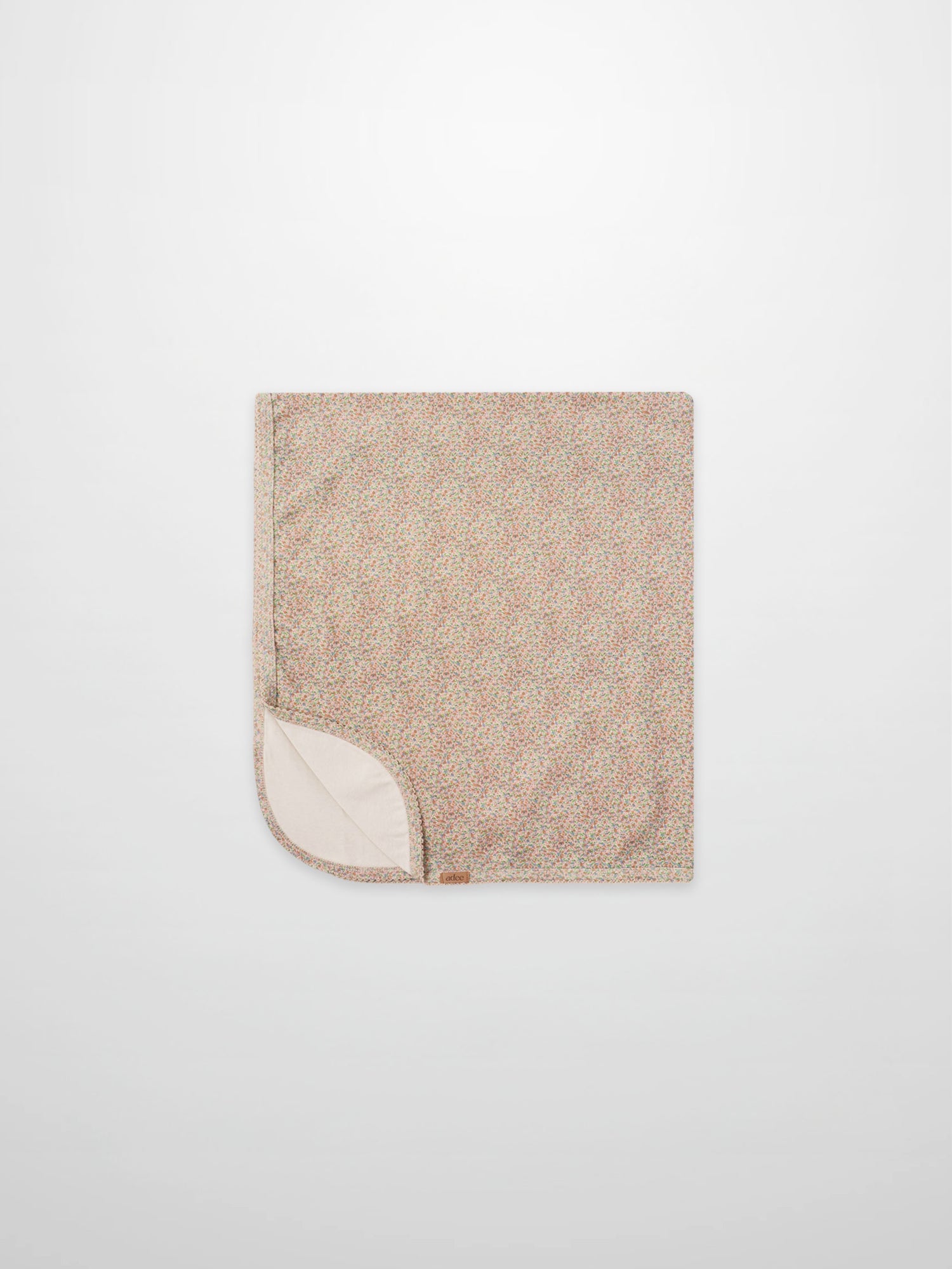 Pastel Petal Blanket swaddle for girls by Adee; pastel floral speckled pattern with cream underside