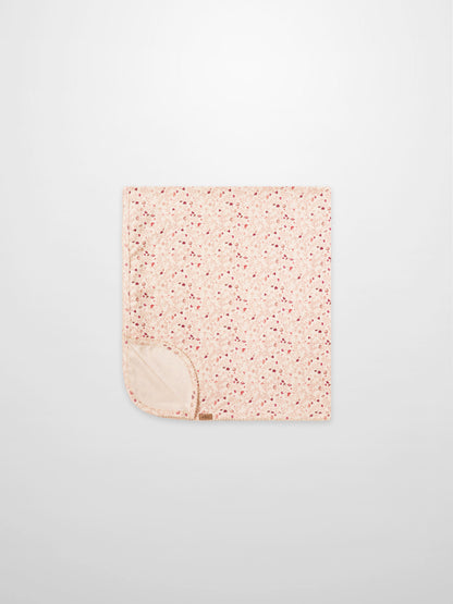 Garden Sprinkles Blanket by Adee; pink floral girls swaddle blanket with beige underside.