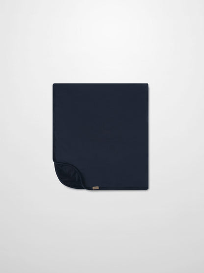 Embroidered Bear Blanket - Navy by Adee; navy boys swaddle blanket with a small corner tag.