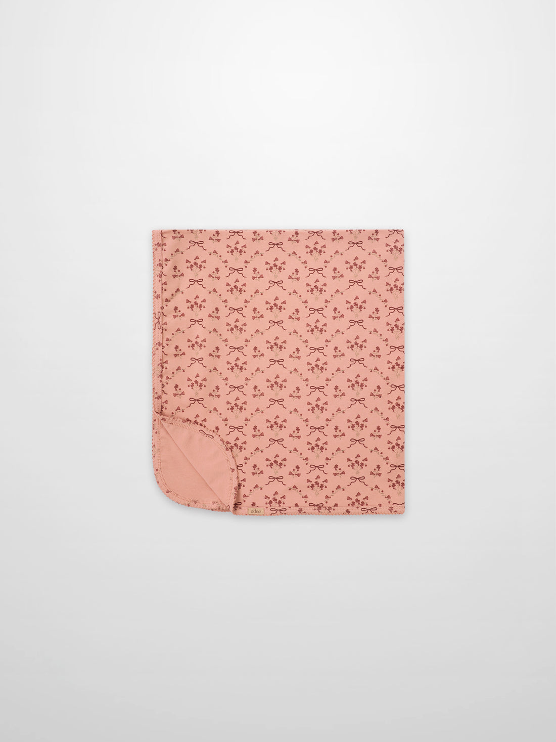 Adee Bow Bouquet Blanket for girls; pink swaddle blanket with small floral bouquets and bow motifs.