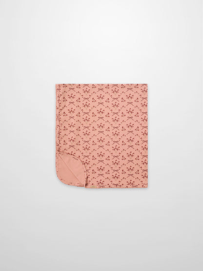 Adee Bow Bouquet Blanket for girls; pink swaddle blanket with small floral bouquets and bow motifs.