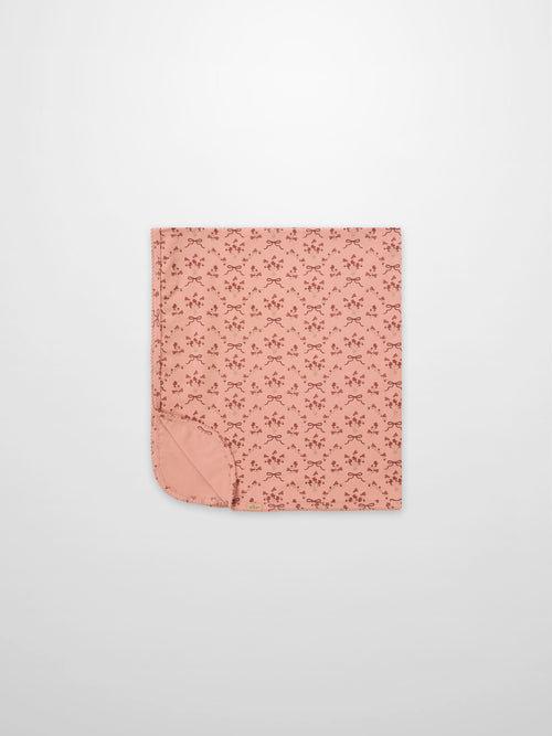 Adee Bow Bouquet Blanket for girls; pink swaddle blanket with small floral bouquets and bow motifs.