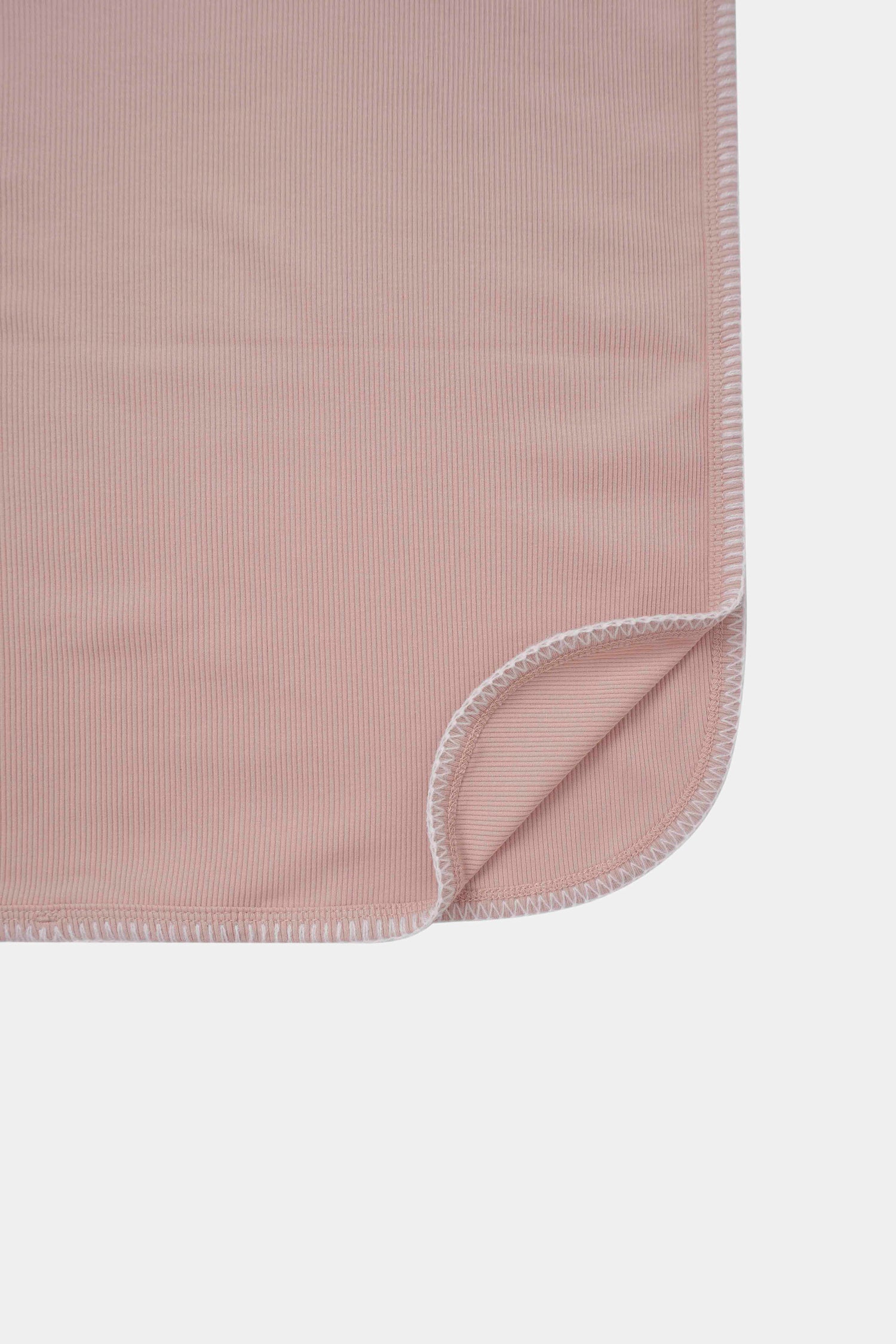 Legacy Stitch Blanket by Adee; light pink ribbed swaddle blanket with white edge stitching.