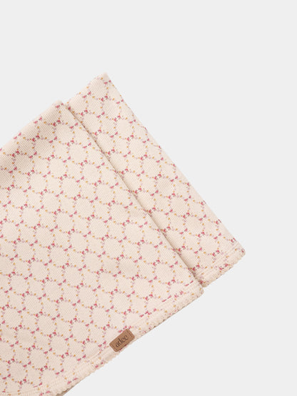 Floral Garland Blanket, pink swaddle blanket with tiny pink and yellow floral pattern, by Adee.