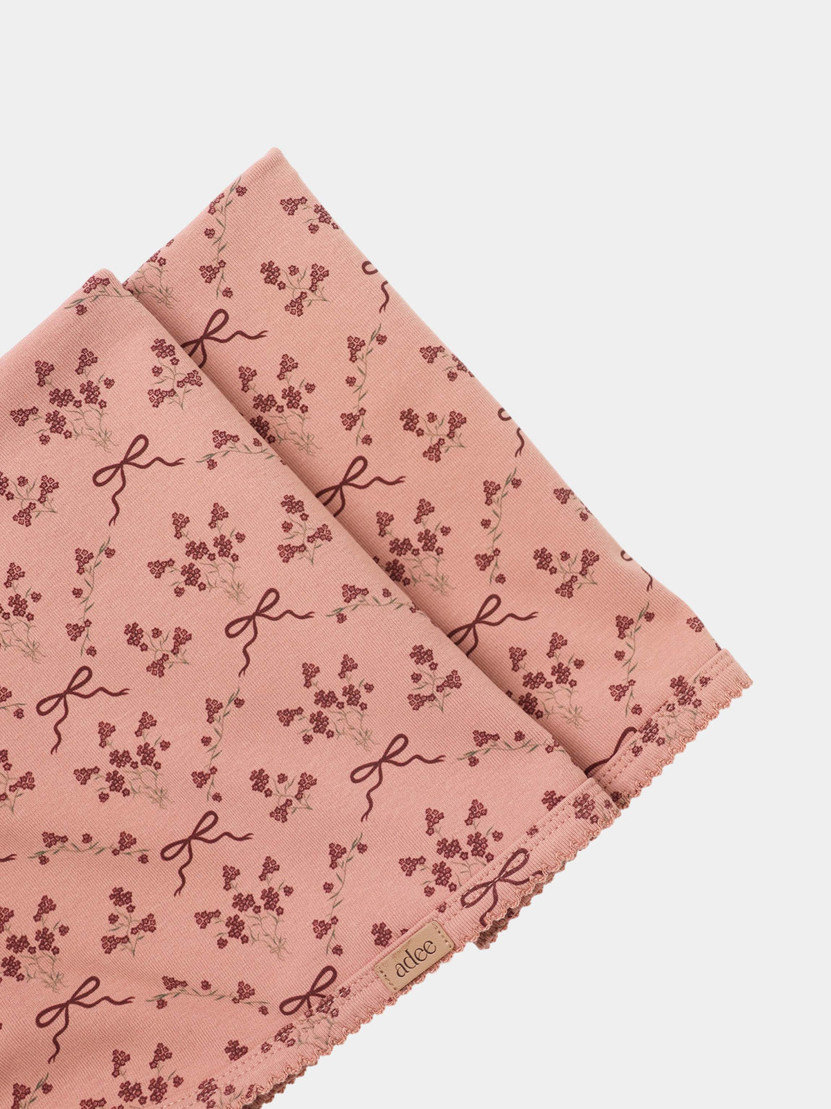 Adee Bow Bouquet Layette Set for girls; pink fabric with tiny floral clusters and ribbon bow motifs.