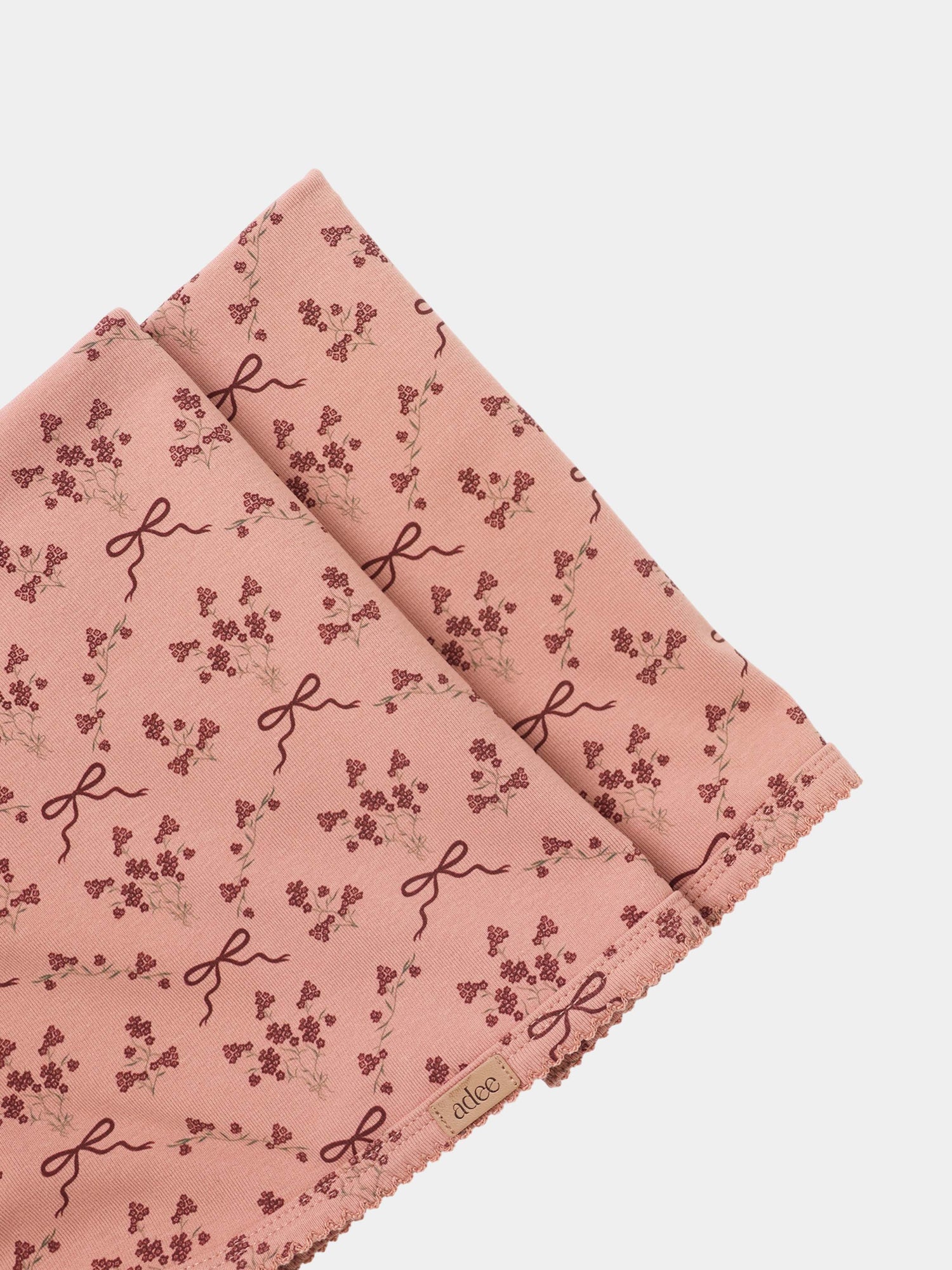 Adee Bow Bouquet Layette Set for girls; pink fabric with tiny floral clusters and ribbon bow motifs.