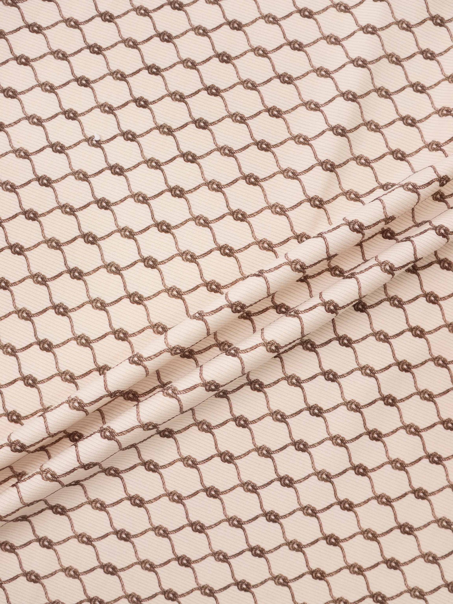 Brown chain blanket swaddle for boys by Adee; beige fabric with repeating brown chain pattern.