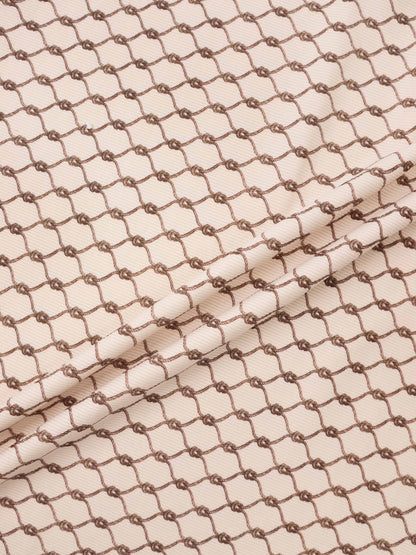 Brown Chain Layette Set fabric by Adee; beige base with brown chain pattern for boys