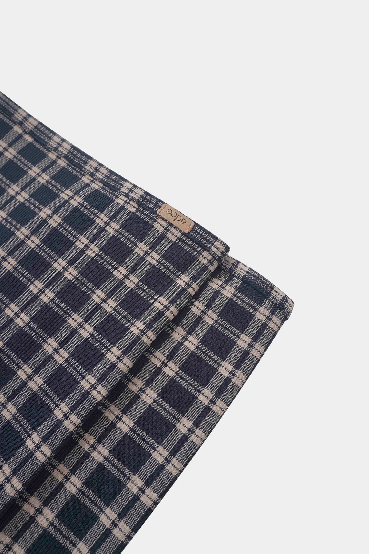 Navy plaid boys swaddle blanket by Adee with navy and beige check pattern.