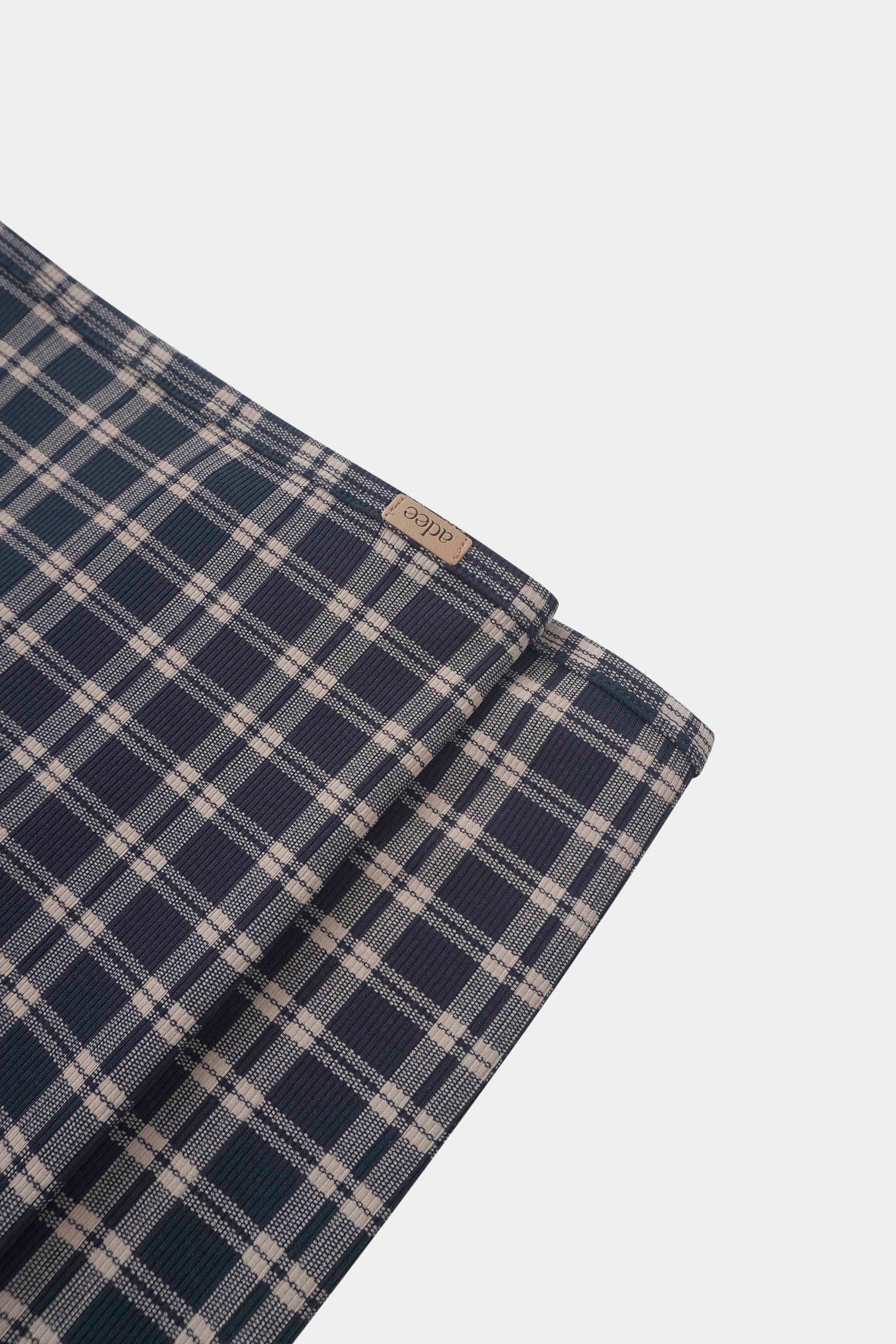 Navy plaid boys swaddle blanket by Adee with navy and beige check pattern.