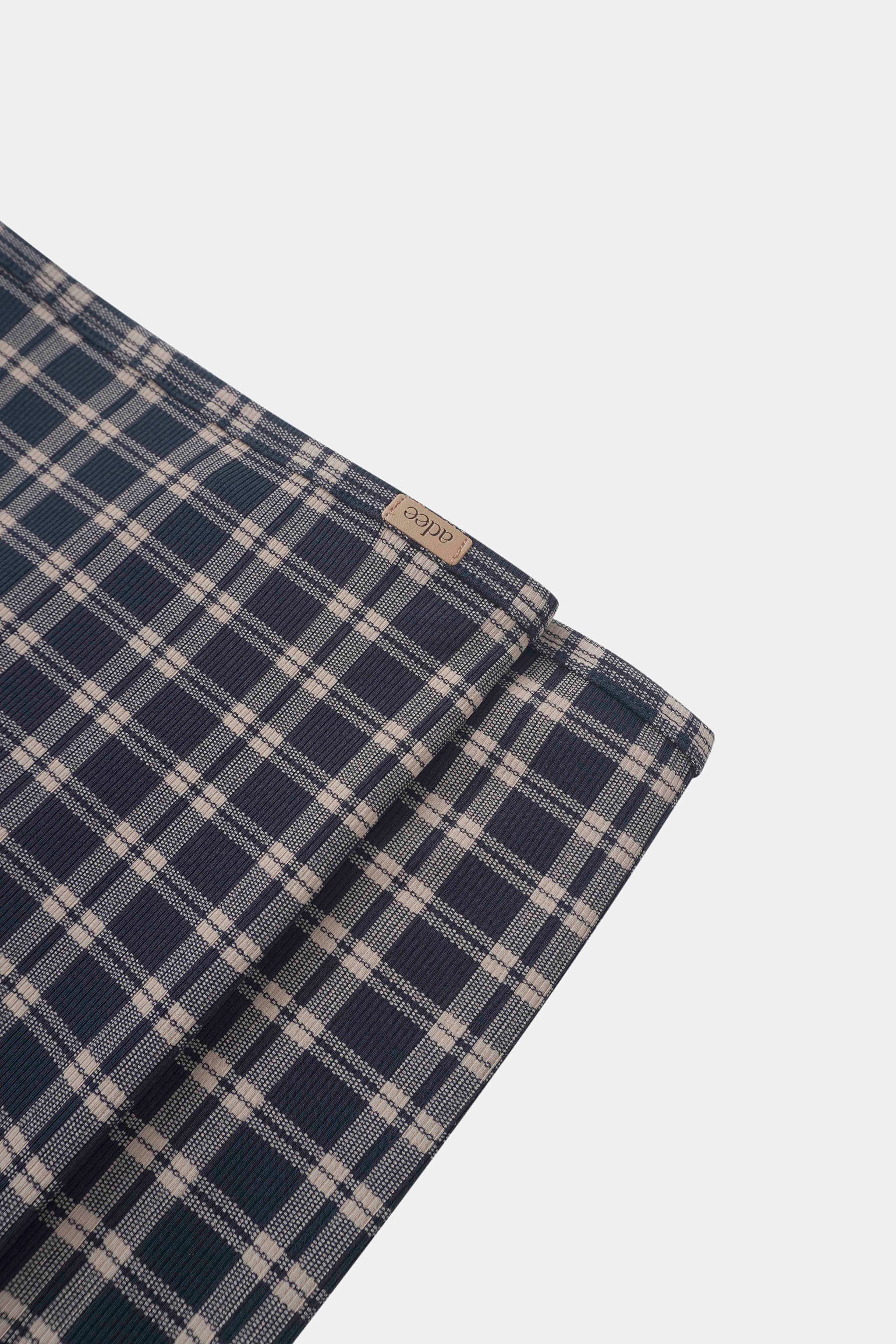 Navy plaid boys swaddle blanket by Adee with navy and beige check pattern.