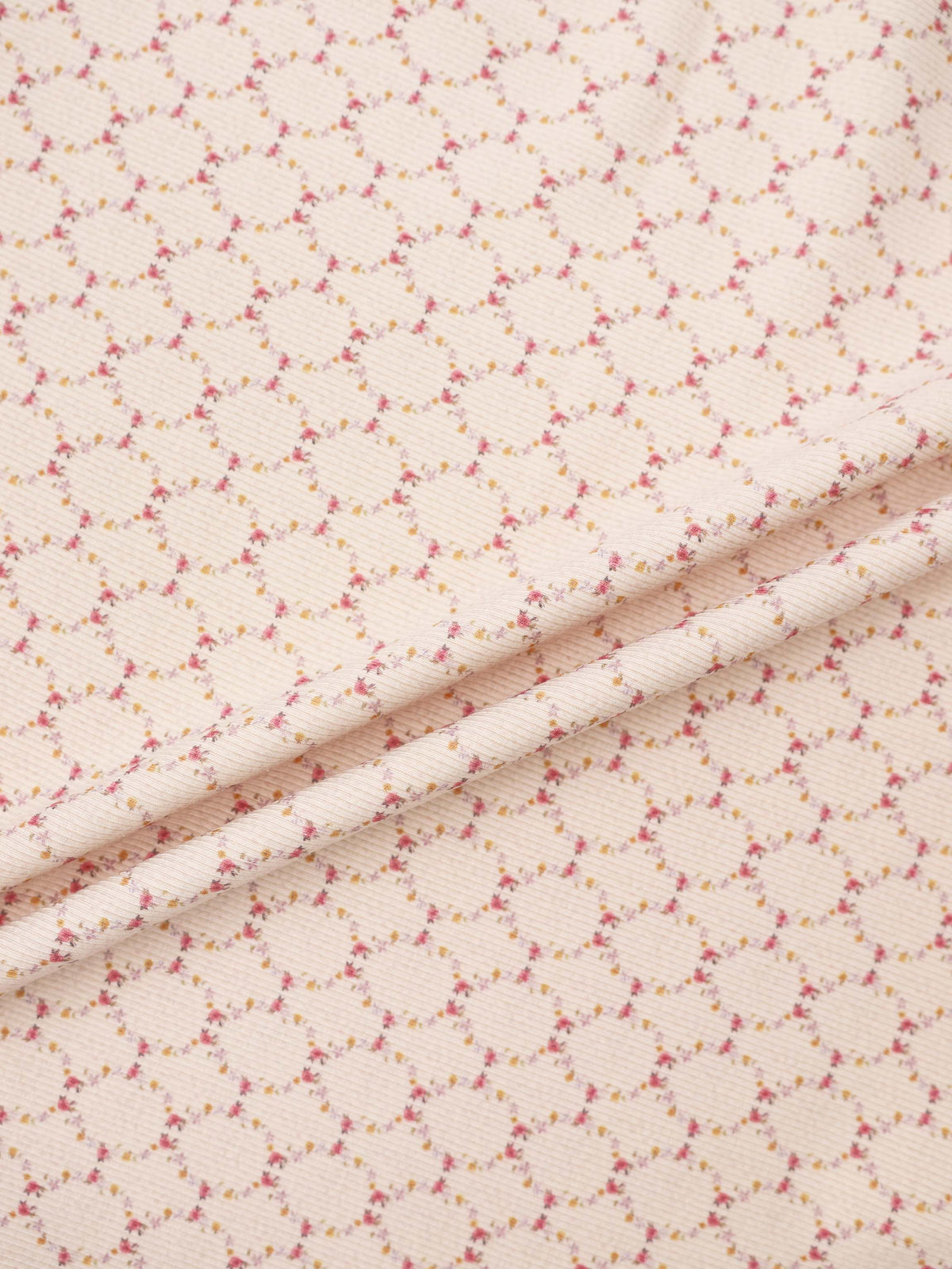 Adee Floral Garland Blanket swaddle for girls; pale pink fabric with tiny pink and yellow floral garlands.