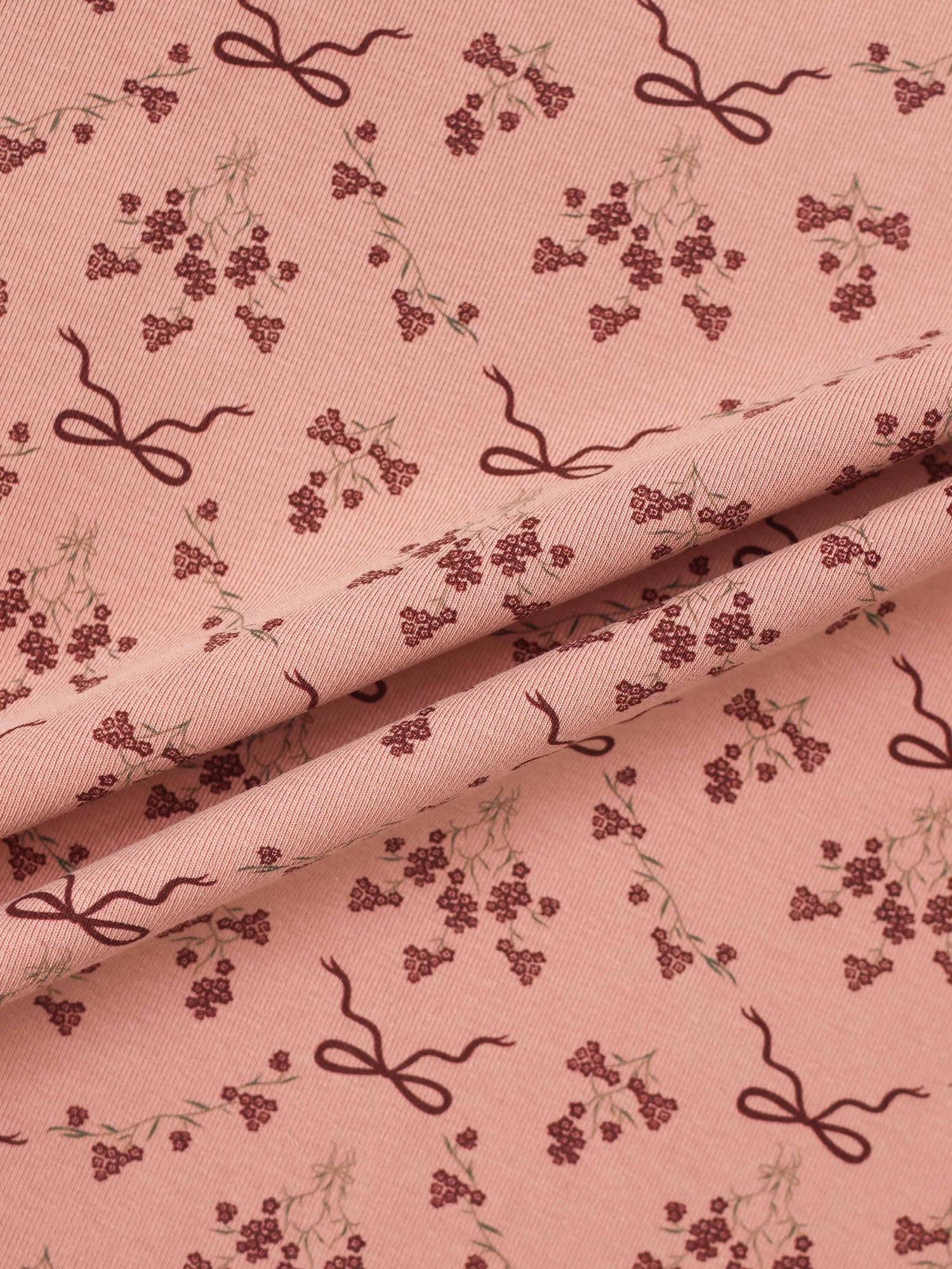 Adee Bow Bouquet layette set fabric in pink with burgundy floral clusters and bow motifs